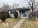 A single-story home featuring a gray exterior, complemented by well-maintained bushes and a cozy front porch at 3728 Orchard Ave, Indianapolis, IN 46218