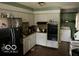 A kitchen featuring ample cabinet space, a stainless steel refrigerator, and essential appliances at 3728 Orchard Ave, Indianapolis, IN 46218