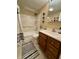 Well-lit bathroom featuring a shower-tub combo with tiled flooring, a modern vanity, and neutral wall colors at 3965 N Meridian St # 7D, Indianapolis, IN 46208