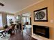 Bright bedroom with hardwood floors, decorative fireplace, ceiling fan, and seating area at 3965 N Meridian St # 7D, Indianapolis, IN 46208