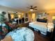 Bright bedroom features hardwood floors, decorative rug, ceiling fan and closet at 3965 N Meridian St # 7D, Indianapolis, IN 46208