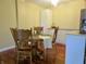 Cozy dining room features a wood table with seating for six under a modern light fixture at 3965 N Meridian St # 7D, Indianapolis, IN 46208