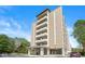 Modern brick apartment building featuring a covered entryway, multiple balconies and mature trees at 3965 N Meridian St # 7D, Indianapolis, IN 46208