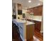 Stylish kitchen featuring stainless steel appliances, wood cabinets, and a peninsula with bar seating at 3965 N Meridian St # 7D, Indianapolis, IN 46208