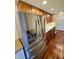 Spacious kitchen features a stainless steel refrigerator, modern appliances, and classic wood cabinets at 3965 N Meridian St # 7D, Indianapolis, IN 46208
