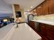Well-lit kitchen with an open layout, stainless steel appliances, white countertops, and warm-toned cabinets at 3965 N Meridian St # 7D, Indianapolis, IN 46208