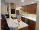 Modern kitchen with stainless steel appliances, sleek countertops, and cherry-stained cabinets for ample storage at 3965 N Meridian St # 7D, Indianapolis, IN 46208