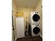 Functional laundry area with a stacked washer and dryer set and convenient storage at 3965 N Meridian St # 7D, Indianapolis, IN 46208