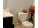 Cozy bathroom featuring a modern vanity, a toilet with a decorative basket, and a stylish decorative vase at 5021 Greenside Dr, Indianapolis, IN 46235