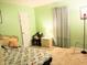 Relaxing bedroom with soft green walls and a patterned floral bedspread. The room is well lit at 5021 Greenside Dr, Indianapolis, IN 46235
