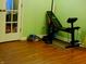 Home exercise area features workout bench with weights and ample space on hardwood flooring at 5021 Greenside Dr, Indianapolis, IN 46235