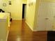 Inviting hallway with beautiful wood flooring, white trim, leading to multiple rooms at 5021 Greenside Dr, Indianapolis, IN 46235