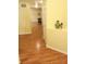 Bright hallway featuring hardwood floors, neutral paint, white trim, and an inviting view into other rooms at 5021 Greenside Dr, Indianapolis, IN 46235