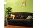 Cozy living room featuring a dark sofa, decorative pillows, and a vibrant piece of floral wall art at 5021 Greenside Dr, Indianapolis, IN 46235