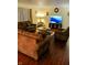 Inviting living room with wood floors, plush sofas, an area rug, lamps, and a TV for a comfortable gathering space at 5021 Greenside Dr, Indianapolis, IN 46235