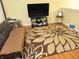 Inviting living room with a large floral rug, comfortable couch, and a modern entertainment center at 5021 Greenside Dr, Indianapolis, IN 46235