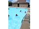 Community pool view with clear blue water, with people swimming and a pool house in the background at 5021 Greenside Dr, Indianapolis, IN 46235
