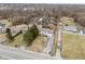 Aerial view of a home with a long driveway, surrounded by trees in a residential area at 5441 E 34Th St, Indianapolis, IN 46218