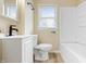 Bright bathroom features a white vanity, matte black faucet and towel rack, and a shower-tub combo at 5441 E 34Th St, Indianapolis, IN 46218