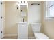 This bathroom features a sleek vanity with matte black accents and ample natural light from the window at 5441 E 34Th St, Indianapolis, IN 46218