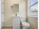 The light-filled bathroom features a modern sink, toilet, and a large window at 5441 E 34Th St, Indianapolis, IN 46218