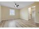 Spacious bedroom with a ceiling fan, window, and wood-look vinyl flooring at 5441 E 34Th St, Indianapolis, IN 46218