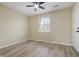 This bedroom features a ceiling fan, wood-look floors, and a window providing natural light at 5441 E 34Th St, Indianapolis, IN 46218