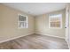 A bright bedroom offers a clean look with two windows and vinyl wood flooring at 5441 E 34Th St, Indianapolis, IN 46218