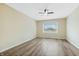 Spacious bedroom with modern flooring, a ceiling fan, and a large window offering plenty of natural light at 5441 E 34Th St, Indianapolis, IN 46218