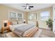 Comfortable bedroom boasts wood-look flooring, ceiling fan, and natural light from multiple windows at 5441 E 34Th St, Indianapolis, IN 46218