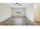 Spacious bedroom with modern flooring, a ceiling fan, and a large window offering plenty of natural light at 5441 E 34Th St, Indianapolis, IN 46218