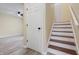 Entryway and staircase feature wood-look floors and a neutral color scheme, creating a welcoming atmosphere at 5441 E 34Th St, Indianapolis, IN 46218