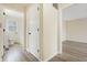 Hallway features neutral paint, wood-look flooring, and access to bathroom and bedroom at 5441 E 34Th St, Indianapolis, IN 46218