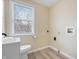 The laundry room features a white sink with window, toilet, and hookups for a washer and dryer at 5441 E 34Th St, Indianapolis, IN 46218