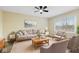 Bright living room featuring a comfortable sofa set, a neutral color palette, and large windows for natural light at 5441 E 34Th St, Indianapolis, IN 46218