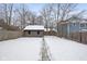 Snowy backyard featuring a storage shed and wood fence at 5444 Carrollton Ave, Indianapolis, IN 46220