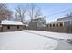 Backyard with a storage shed, wood fence, and snow covered lawn at 5444 Carrollton Ave, Indianapolis, IN 46220