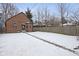 Large backyard with a brick home, a well-maintained lawn and wooden fence at 5444 Carrollton Ave, Indianapolis, IN 46220