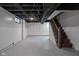 Spacious basement with painted floors, exposed ceilings, and ample storage space at 5444 Carrollton Ave, Indianapolis, IN 46220