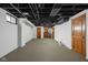 Basement with neutral carpet, wooden doors, and some storage at 5444 Carrollton Ave, Indianapolis, IN 46220
