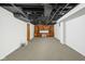 Spacious carpeted basement with built-in shelving and storage at 5444 Carrollton Ave, Indianapolis, IN 46220
