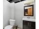 Basement bathroom with a single vanity and a large mirror at 5444 Carrollton Ave, Indianapolis, IN 46220