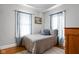 Comfortable bedroom with blue accents, natural light, and hardwood floors at 5444 Carrollton Ave, Indianapolis, IN 46220