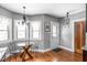 Cozy breakfast nook featuring a glass table, hardwood floors, and a charming chandelier at 5444 Carrollton Ave, Indianapolis, IN 46220