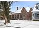Charming brick home featuring arched windows and snow covered roof, offering classic architectural details at 5444 Carrollton Ave, Indianapolis, IN 46220