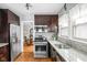 Modern kitchen with stainless steel appliances, granite countertops, and hardwood floors at 5444 Carrollton Ave, Indianapolis, IN 46220