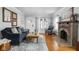 Cozy living room with hardwood floors, brick fireplace, and comfortable seating at 5444 Carrollton Ave, Indianapolis, IN 46220