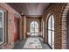 Inviting brick porch with seating area, arched openings, and a stylish patterned rug at 5444 Carrollton Ave, Indianapolis, IN 46220
