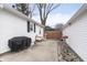 Backyard area showcases a white house with a grill and a fenced off gravel area at 603 W Pearl St, Lebanon, IN 46052