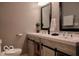 Elegant bathroom featuring double sinks with granite counters and modern fixtures at 621 W 10Th St, Indianapolis, IN 46202